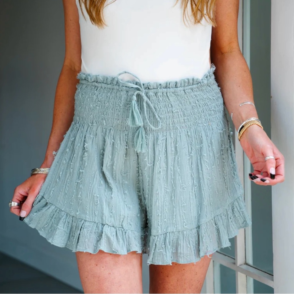 Mustard Seed smocked waist tassel tie flounce shorts